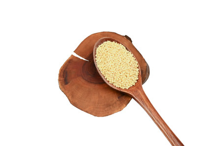 Wooden spoon and millet on an isolated background.の写真素材