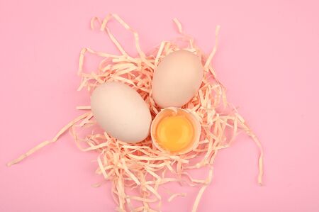 Eco eggs on a pink background. minimalistic trend, top view. Egg tray. Easter conceptの写真素材
