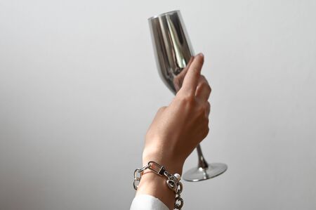 Female hand with jewelry and a glass. High quality photoの写真素材