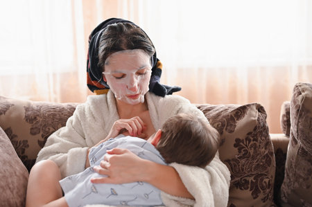 Portrait of a tired breast-feeding girl, with a moisturizing face mask.の写真素材