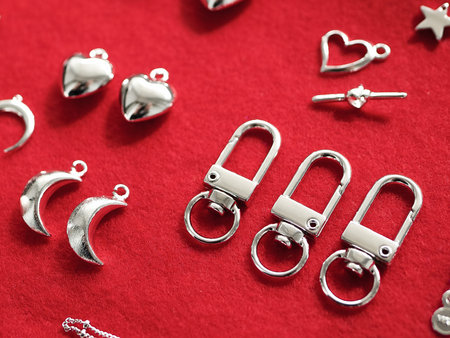 Making jewelry from silver. on a red background. High quality photo