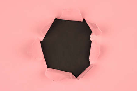 Pink tear paper, on blackの写真素材