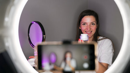 Blogger girl shows skin cream. High quality photoの写真素材