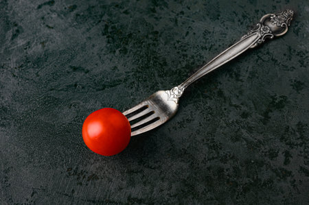 one tomato on a fork. High quality photo