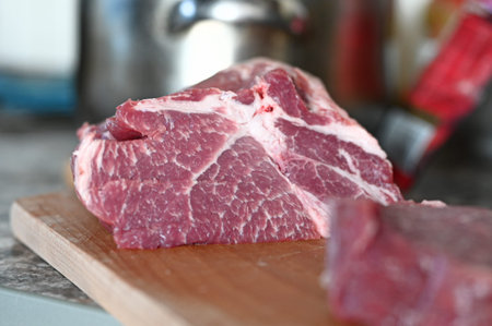 fresh piece of meat streaked with bacon on the table. High quality photo