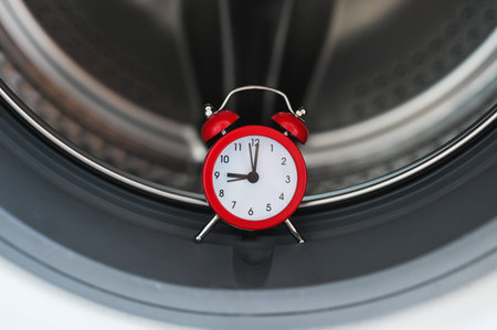Washing machine and clock. Washing time concept