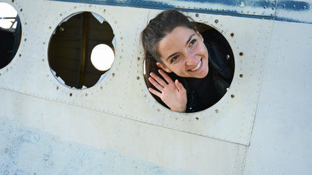 The girl looks out the window of the plane. High quality photoの写真素材