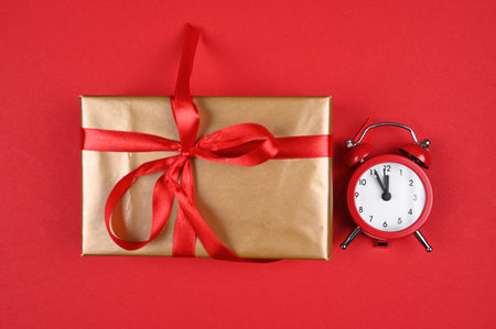 red watch and gift wrap on a red background. High quality photoの写真素材