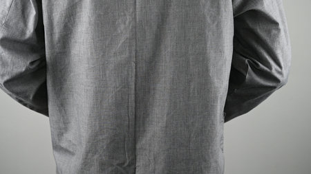 Man in gray pajamas, on a gray background. High quality photo
