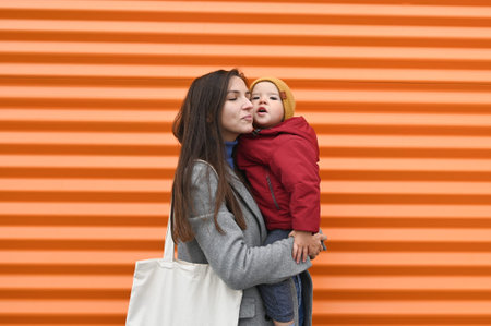 Mom with baby on orange background