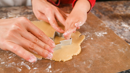 Mom and child make a mold for New Year's cookies. High quality photo