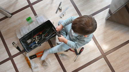 Child playing with household tools. High quality photoの写真素材