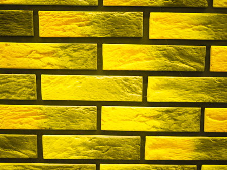 Background from a yellow brick wall. presentation of fashion colors 2021. High quality photoの写真素材