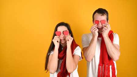 Blinded by love couple, on a yellow background. High quality photoの写真素材
