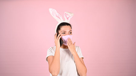 Girl with ears in a mask with a phone. High quality photoの写真素材