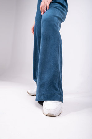 flared trousers, blue, worn on a girl, close-up. High quality photo