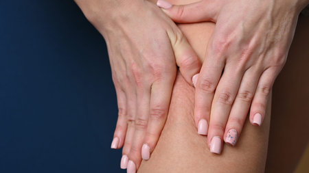 Woman doing foot massage with hands, close-up. High quality photo