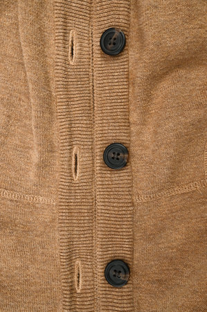 Brown sweater with buttons, close up. High quality photo