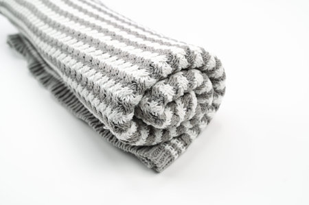 Gray white towel with stripes, on an isolated white background. High quality photo