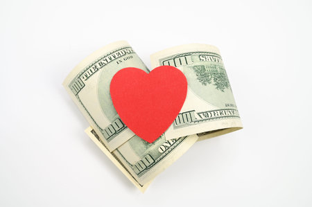 Dollars and heart, on an isolated white background. High quality photo