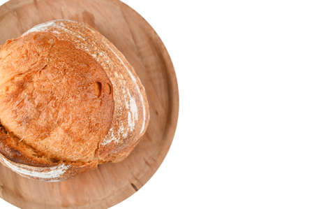 Round homemade bread on a wooden plank, on an isolated background. High quality photoの写真素材