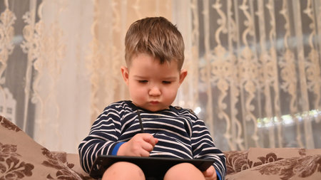 Child draws on a graphics tablet. High quality photoの写真素材