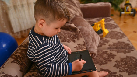 Child draws on a graphics tablet. High quality photo