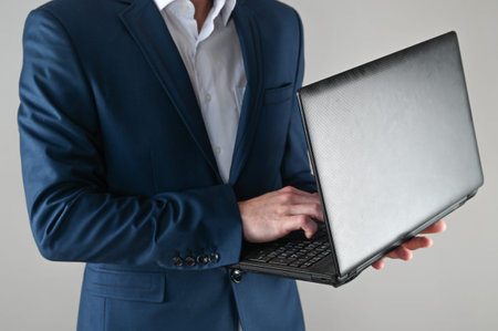 A man in a suit is working on a laptop. High quality photoの写真素材