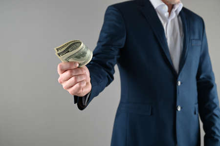 a man in a suit holds money in his hands. High quality photoの写真素材