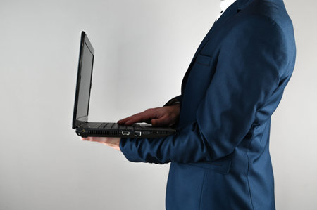 A man in a suit is working on a laptop. High quality photoの写真素材