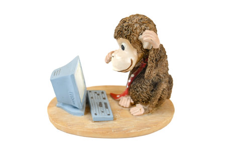 Monkey at the computer, statuette on an isolated background. High quality photoの写真素材