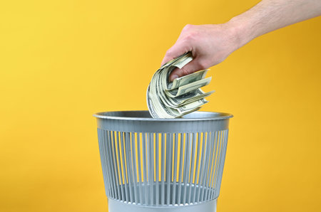 Money is thrown into the trash. High quality photoの写真素材