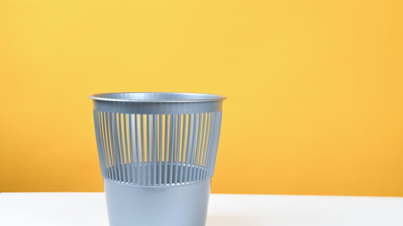 trash can for waste, on a yellow background. High quality photo