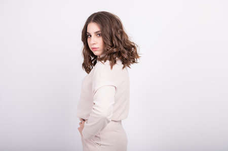 Portrait of pleasant-looking Caucasian female with brown hair wearing beige casual suit. High quality photoの写真素材