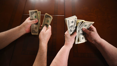 Top view of an old married couple are counting the cash savings, close-up