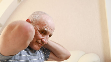 elderly man with neck pain.