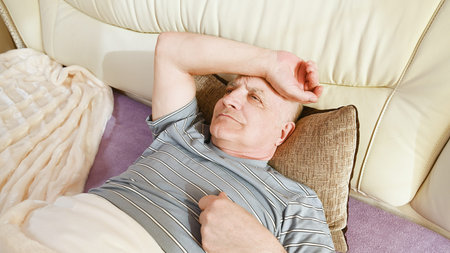 An older man has a headache.