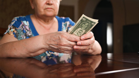 Close up of woman's hands counting US dollar bills. Saving conceptの写真素材