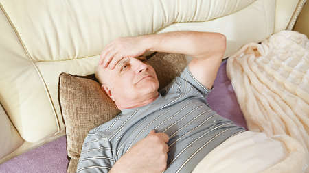 An older man has a headache.の写真素材