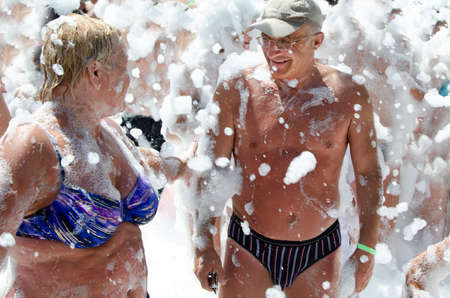 Elderly couple at foam party.の写真素材