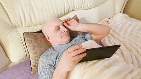 An older man has a headache.の写真素材