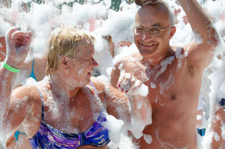 Elderly couple dancing at the beach party.の写真素材