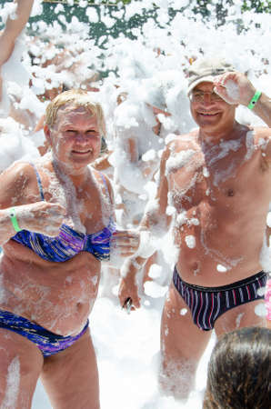 Elderly couple at foam party.の写真素材