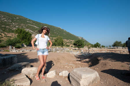 Girl tourist on the background of ancient buildings.の写真素材