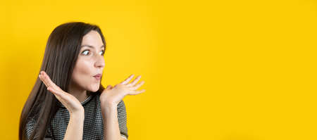 Banner of a surprised young girl, on a yellow background.の写真素材