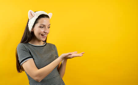 Young girl with ears, on a yellow background.の写真素材