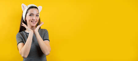Young girl with ears, on a yellow background.の写真素材