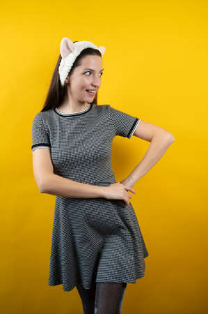 Young girl with ears, on a yellow background.の写真素材