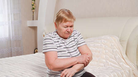 Elderly woman with pain in her arms.の写真素材