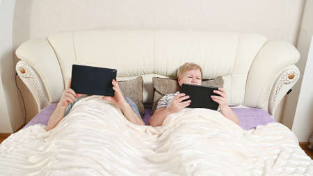 elderly couple with mobile devices.の写真素材